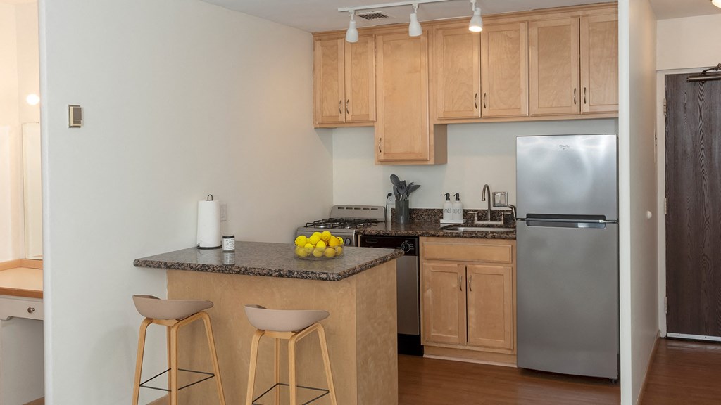 a kitchen with wooden cabinets and stainless steel appliances