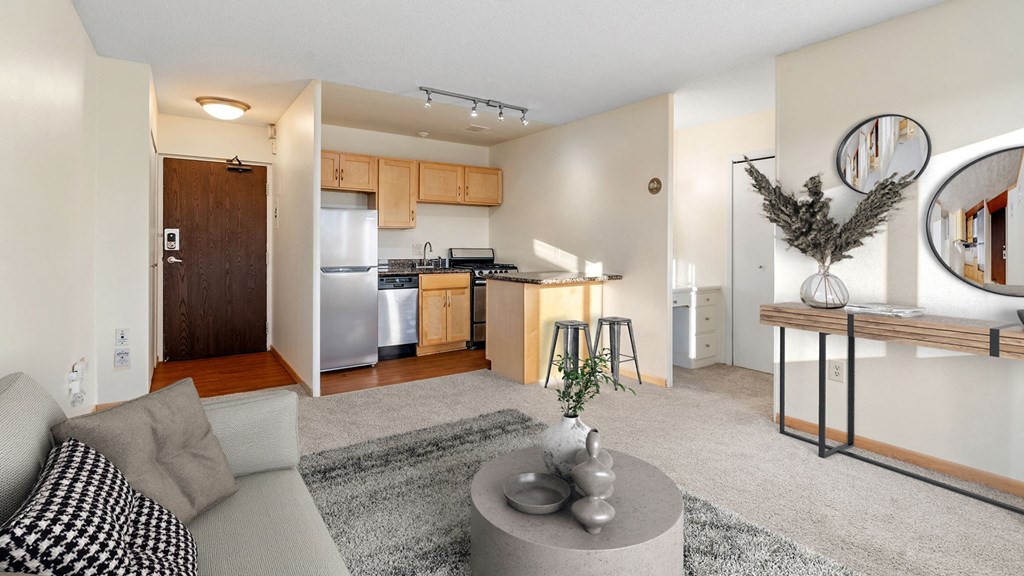 an open living room and kitchen with a couch and a table