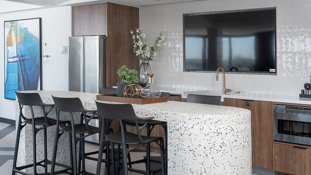 a kitchen with a large counter with a white counter top