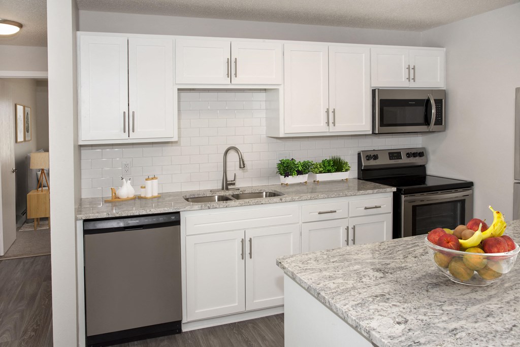 Full Kitchen with White Cabinetry, Stainless Steel Appliances, and Granite Counter Tops