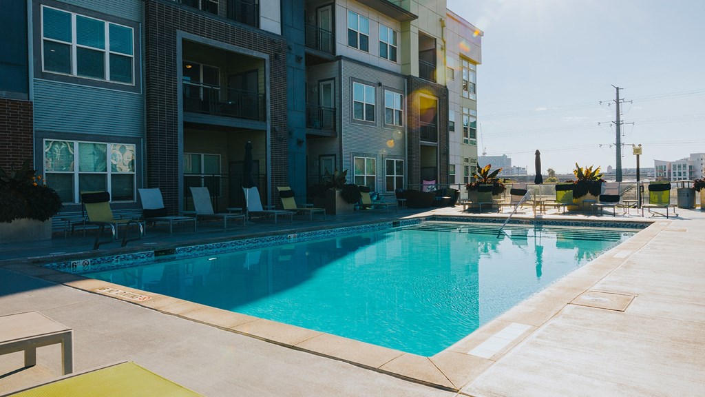 a swimming pool in front of an apartment building