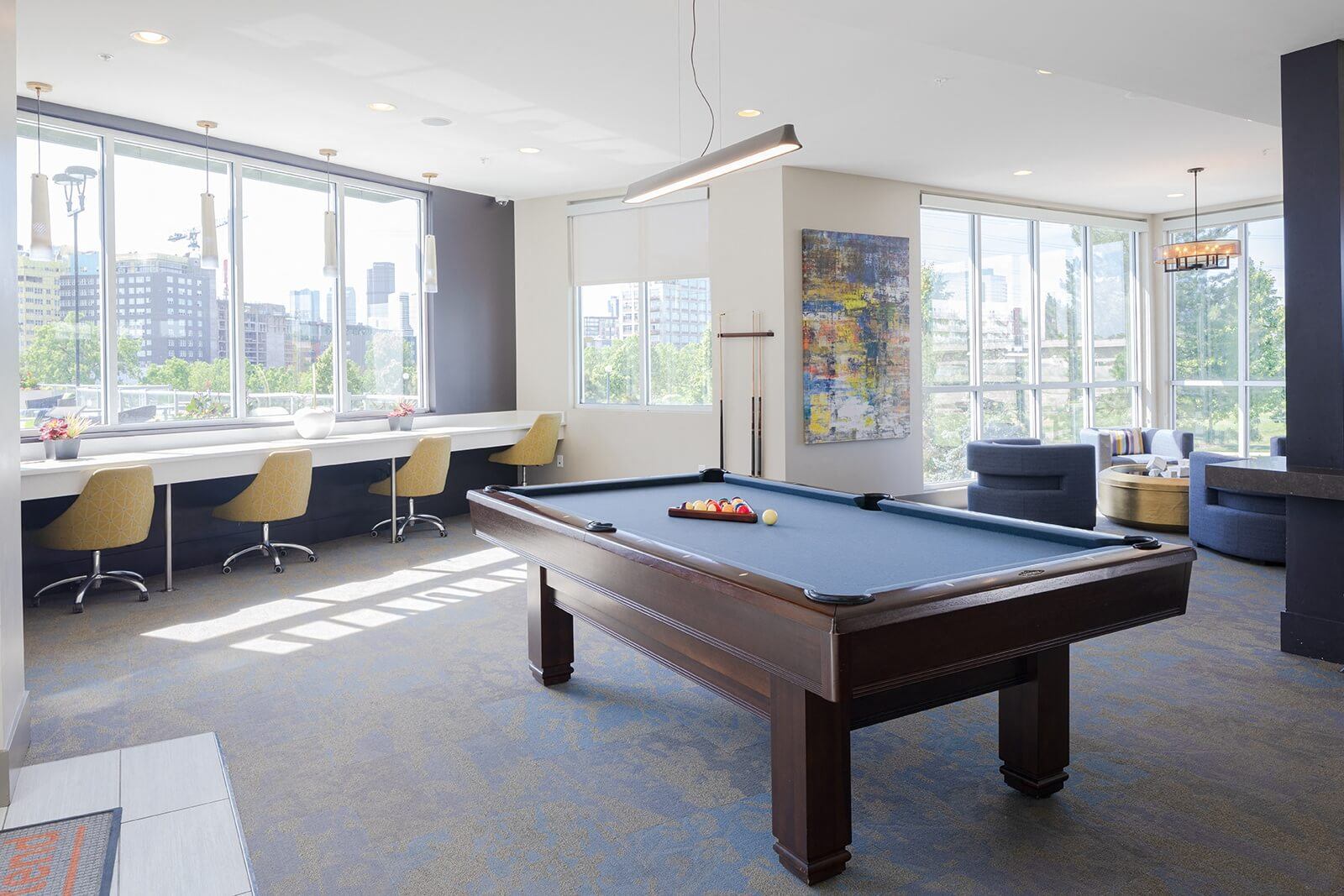 a pool table in a room with large windows