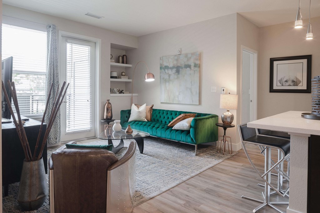 Open living area with stylish plank flooring throughout the space and large windows.