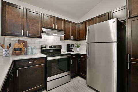a kitchen with stainless steel appliances and wooden cabinets