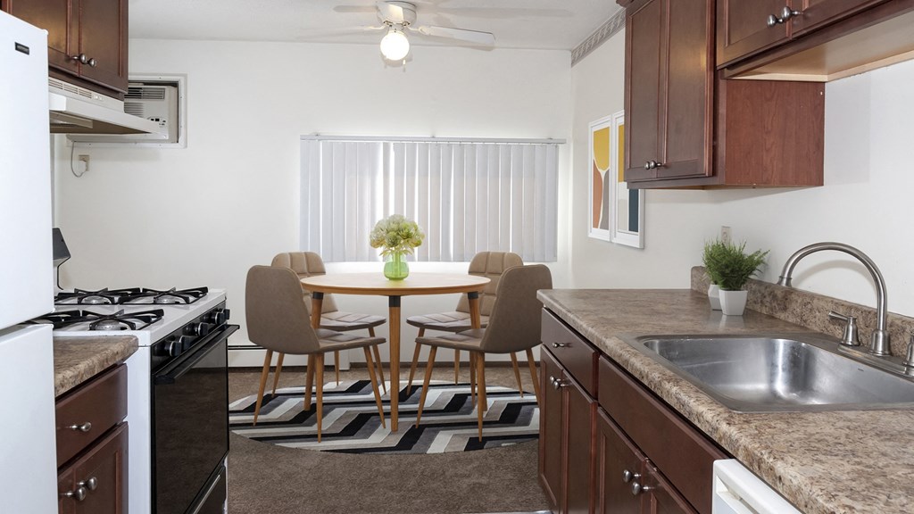 a kitchen and dining room with a table and chairs