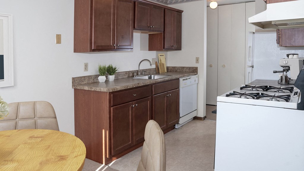a kitchen with a stove top oven and a sink