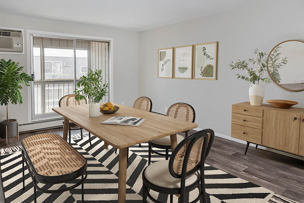 a dining room with a table and chairs and a window