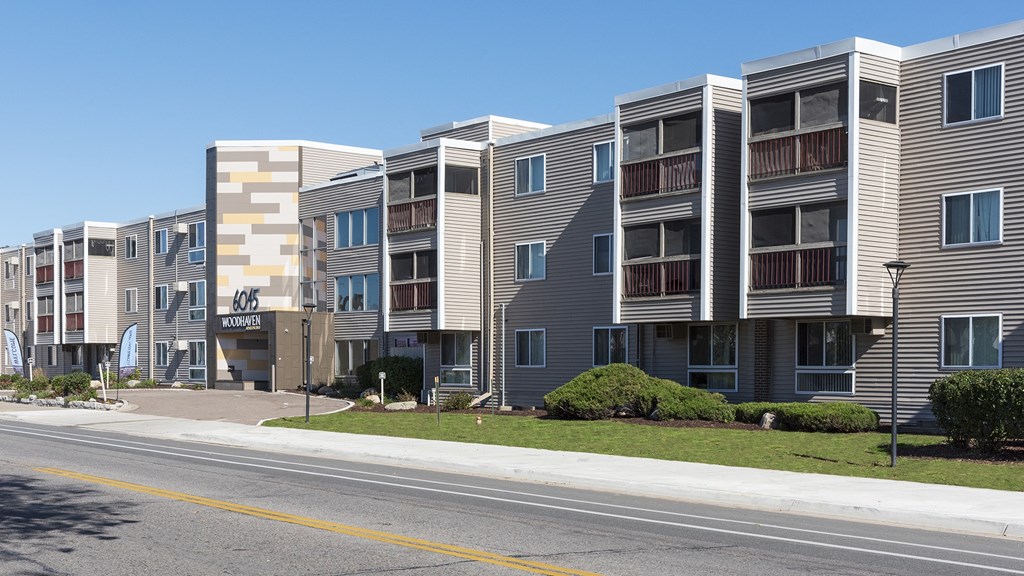 an apartment building with a street in front of it