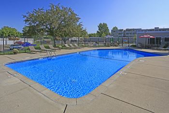 Outdoor swimming pool with blue water and concrete pool deck