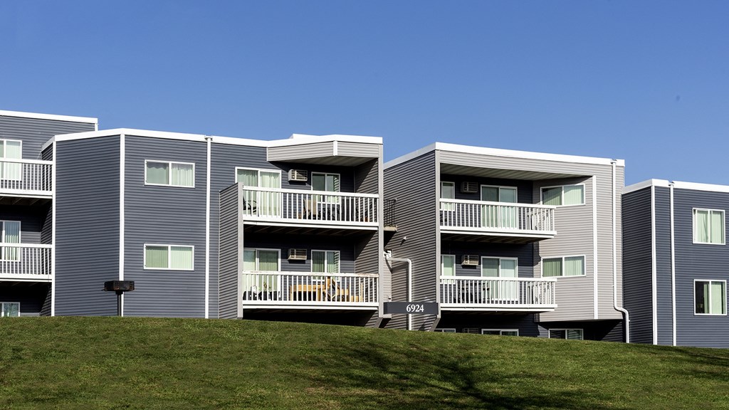 a row of houses with balconies on a hill