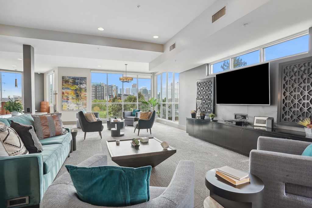 A modern living room with a large window overlooking the city.