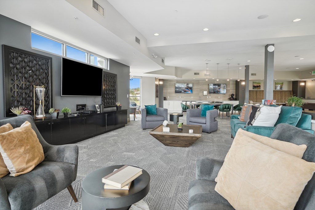 A living room with grey couches and a television.