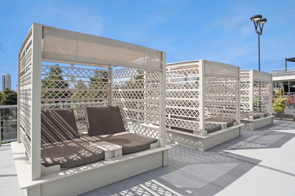 A white outdoor seating area with a lattice design.