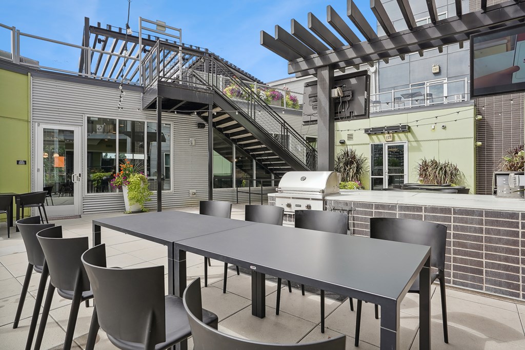 A patio with a table and chairs and a staircase.
