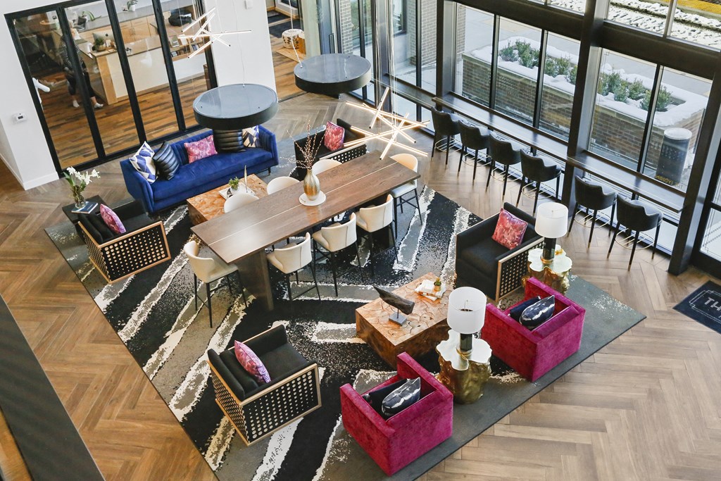 an aerial view of the lobby of a hotel with couches and tables