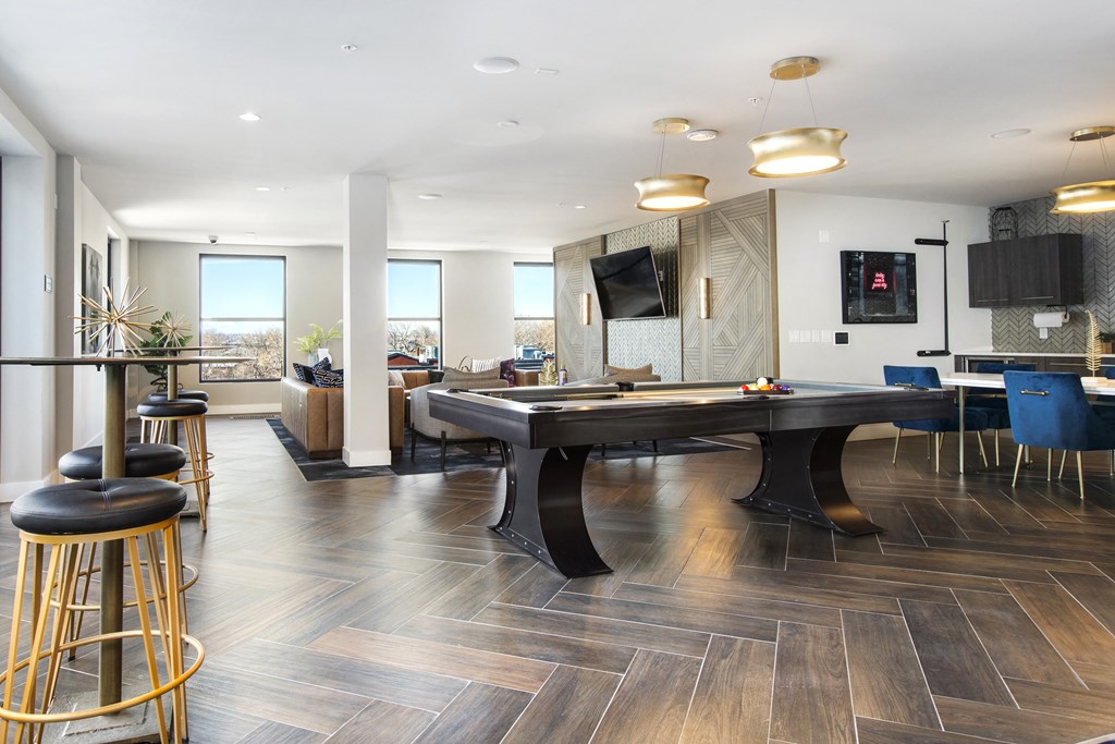 a living room with a pool table and a bar