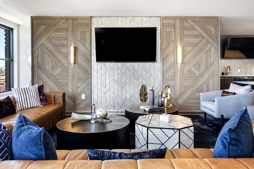 a living room with couches and tables and a television