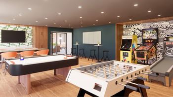 a recreation room with a foosball table and arcade games
