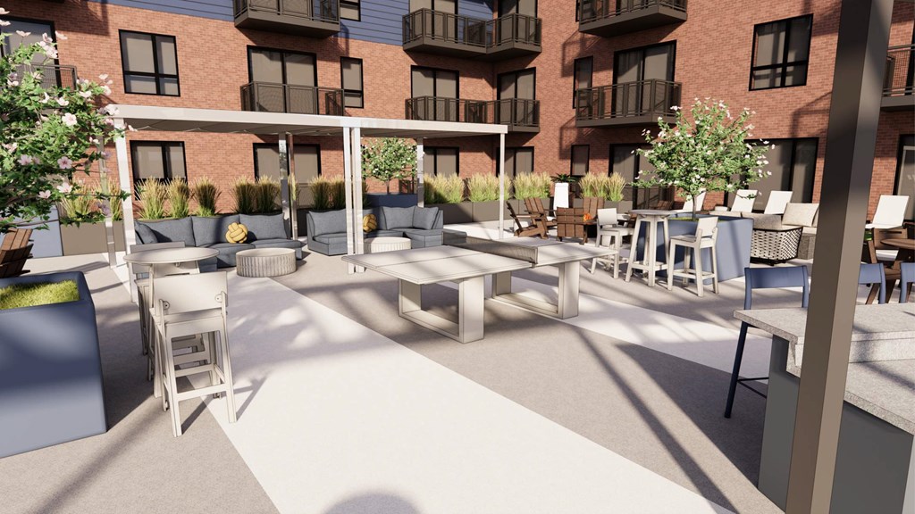 A courtyard with tables and chairs and a building in the background.