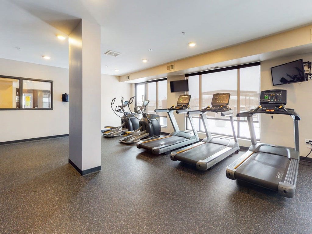 Fitness center with hard rubber flooring, 3 treadmills and 2 ellipticals