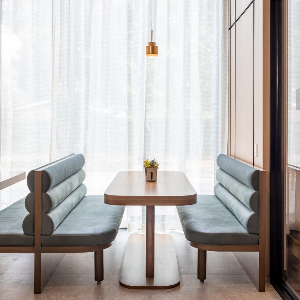 a table and two chairs in front of a window