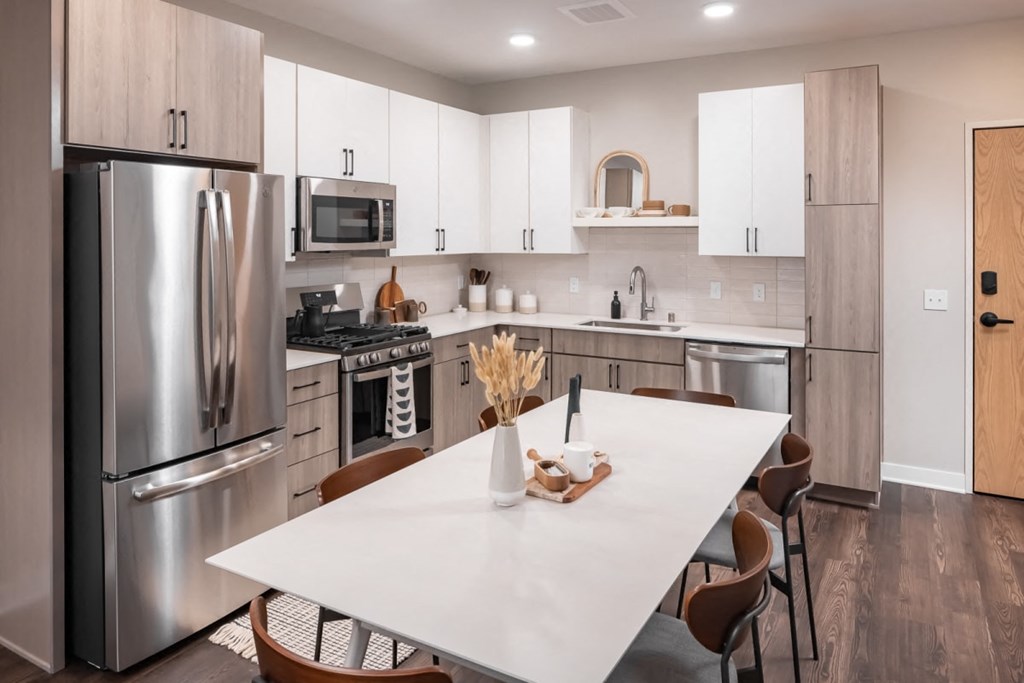a kitchen with white cabinets and stainless steel appliances