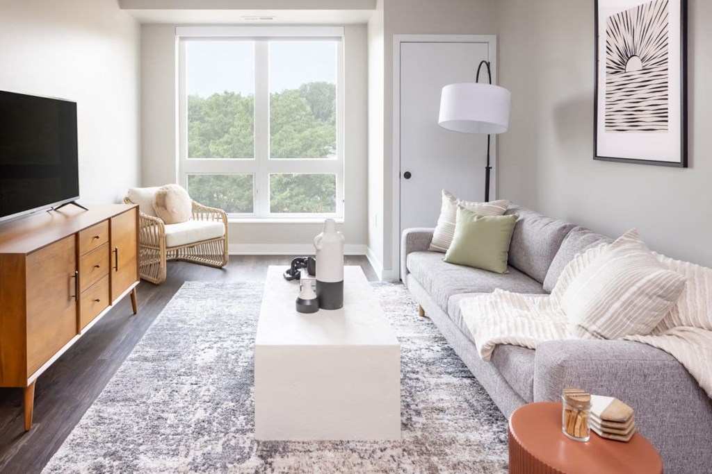 a living room with a gray couch and a white coffee table