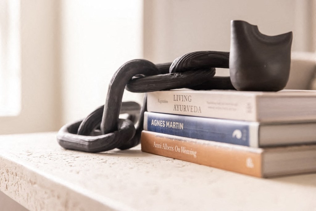 a stack of books on a table with a lock on top of them