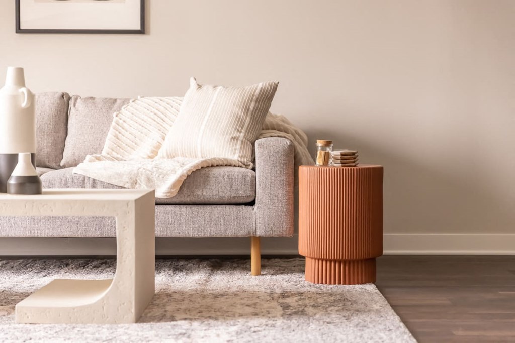 a living room with a sofa and side table