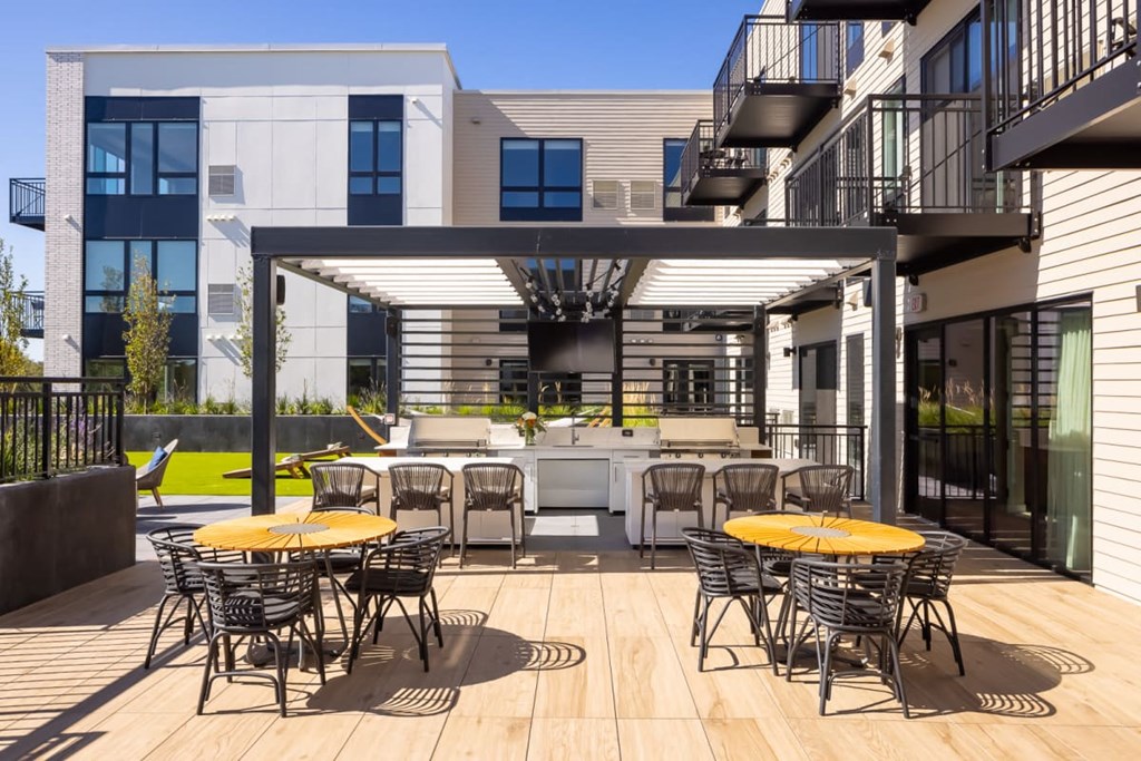 a patio with yellow tables and chairs
