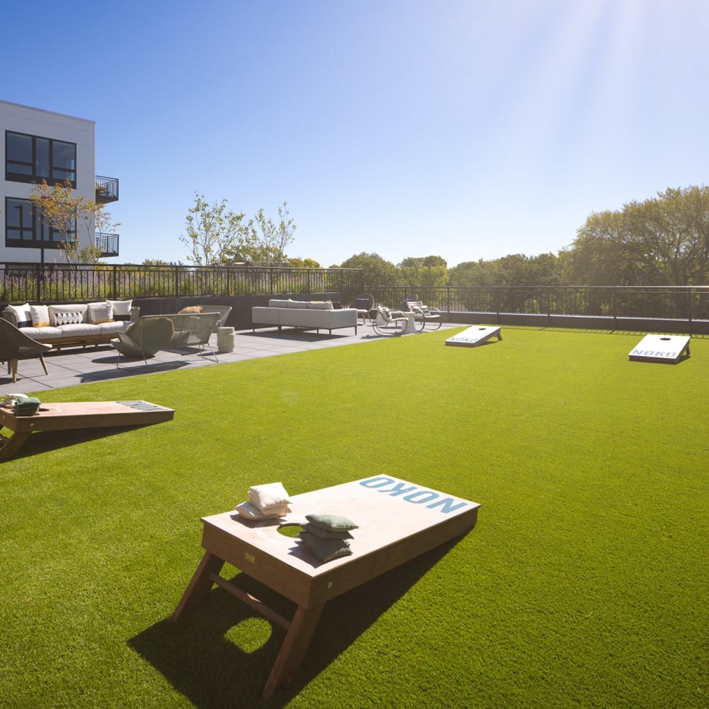 a lounge area on the roof of a building with a blue sky in the background