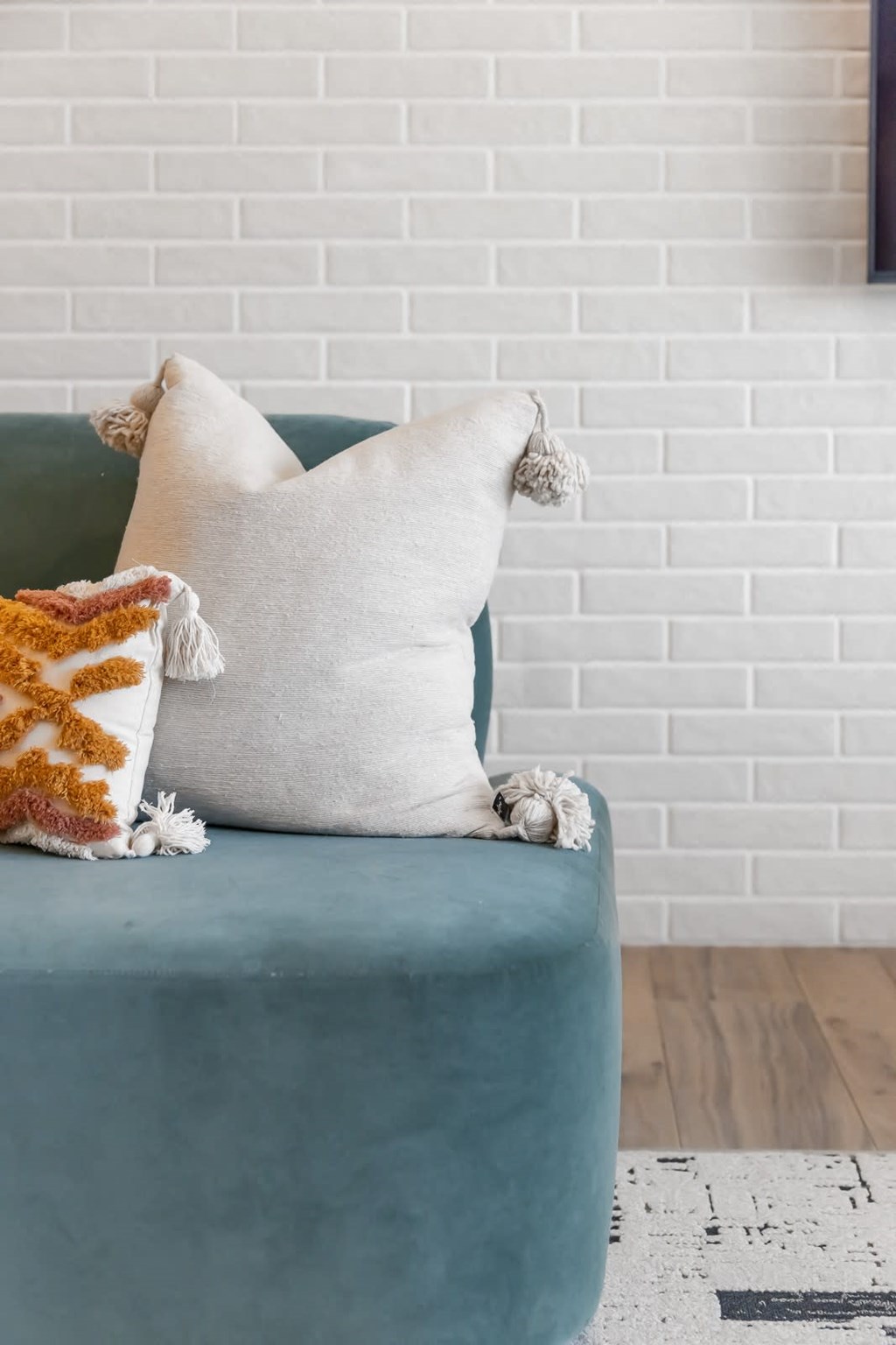 a blue chair with a white cushion and a brown and white pillow on top of it