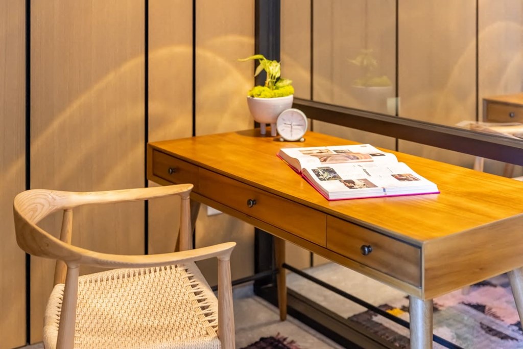 a desk with a book and a clock on top of it