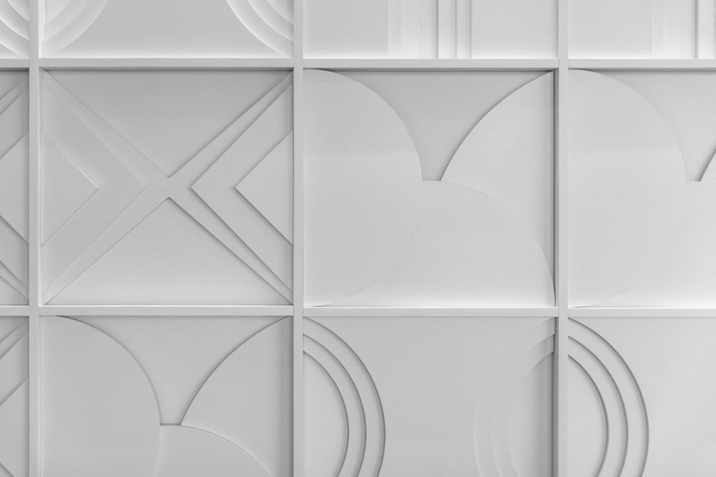 a white wall with a geometric design on it