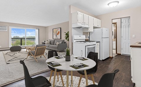 A modern kitchen with a dining table set for two.