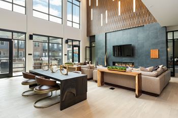 A modern living room with a fireplace and a large window.