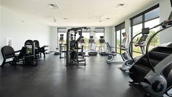 A gym with a variety of exercise equipment.