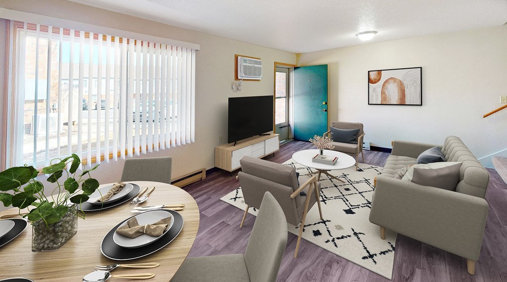 A living room with a grey couch, a wooden table, and a television.