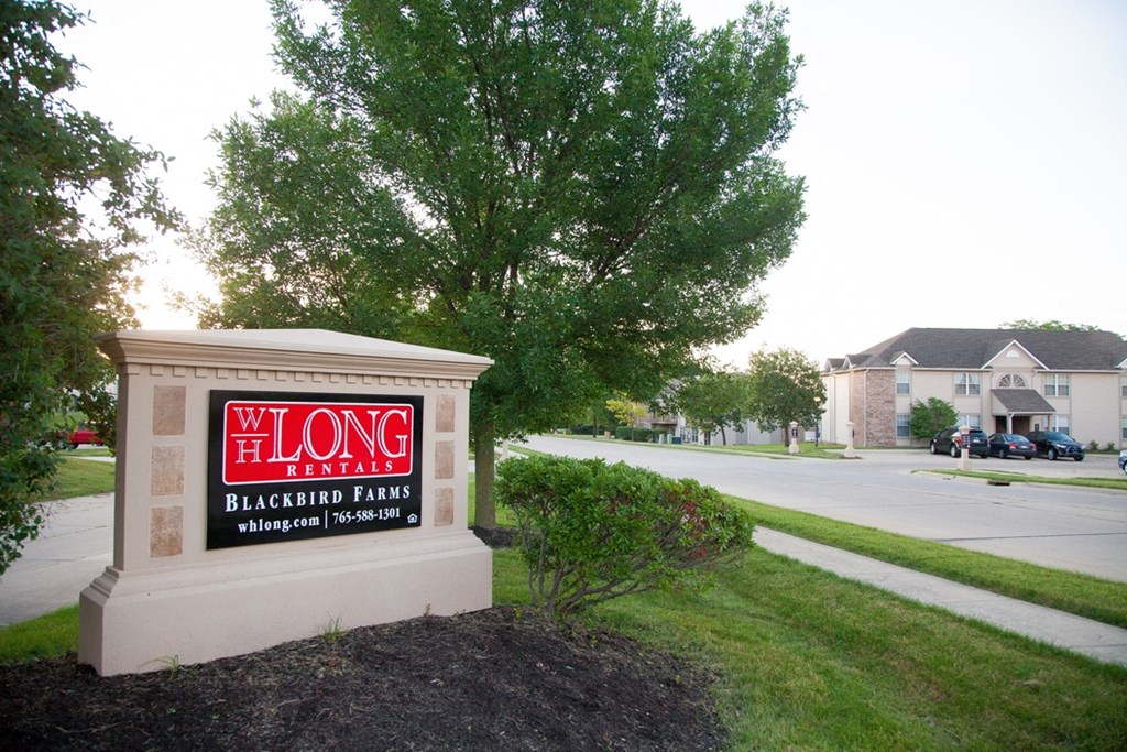 a sign for the long island black bear tavern on the side of a street