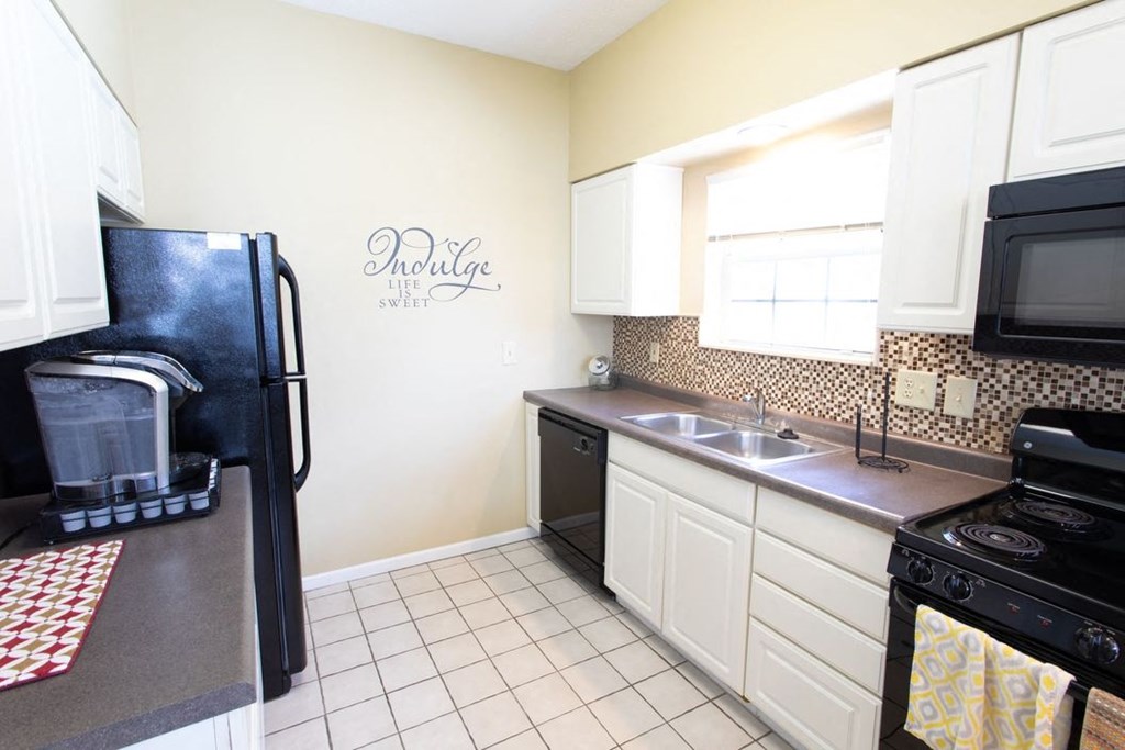 a kitchen with a sink and a refrigerator