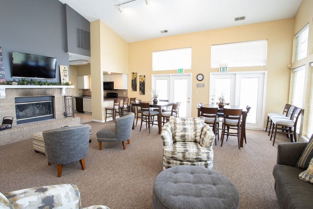 a living room with a fireplace and a table and chairs