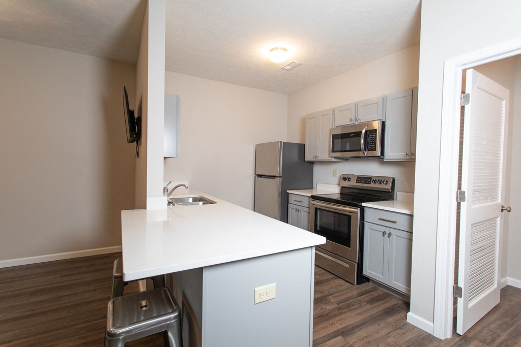a kitchen with stainless steel appliances and a white counter top