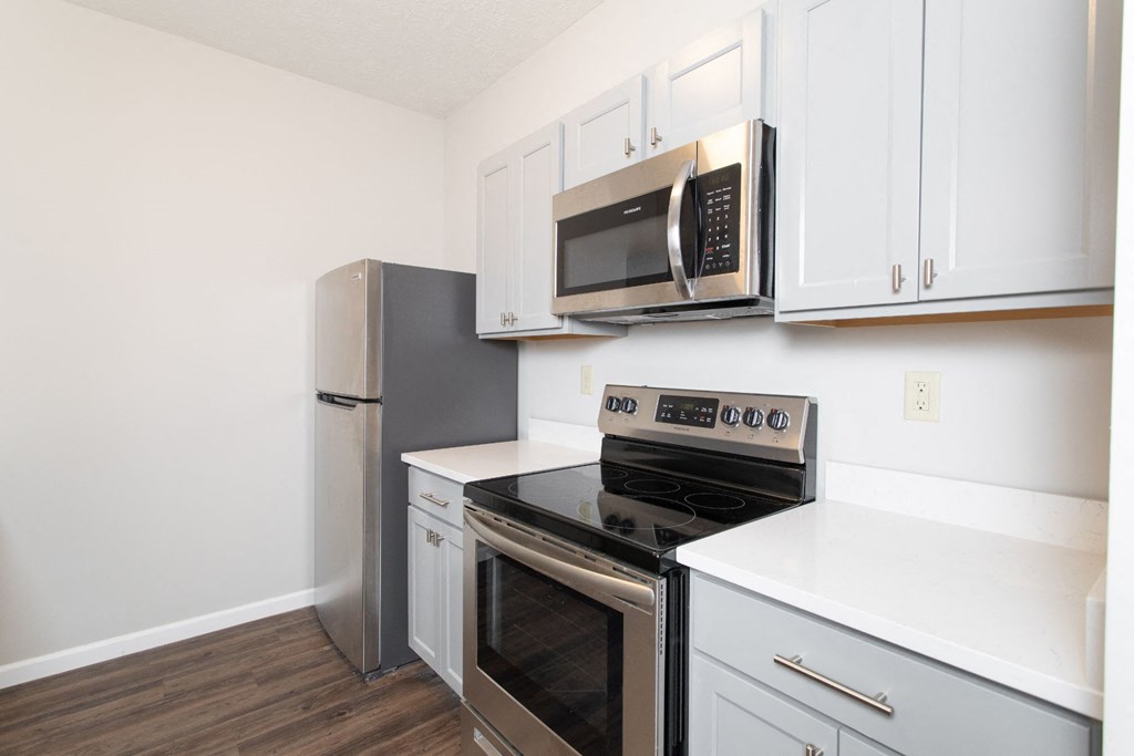a kitchen with stainless steel appliances and white cabinets