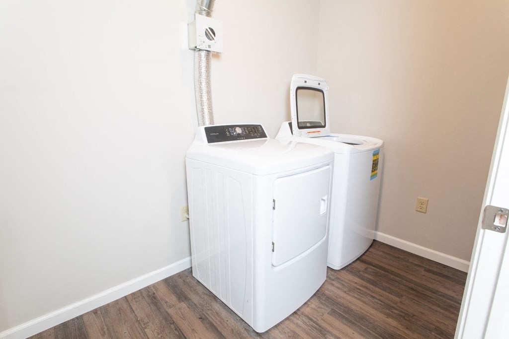 a room with a washing machine and a mirror