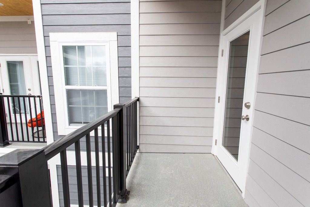 the front of a house with a staircase and a door