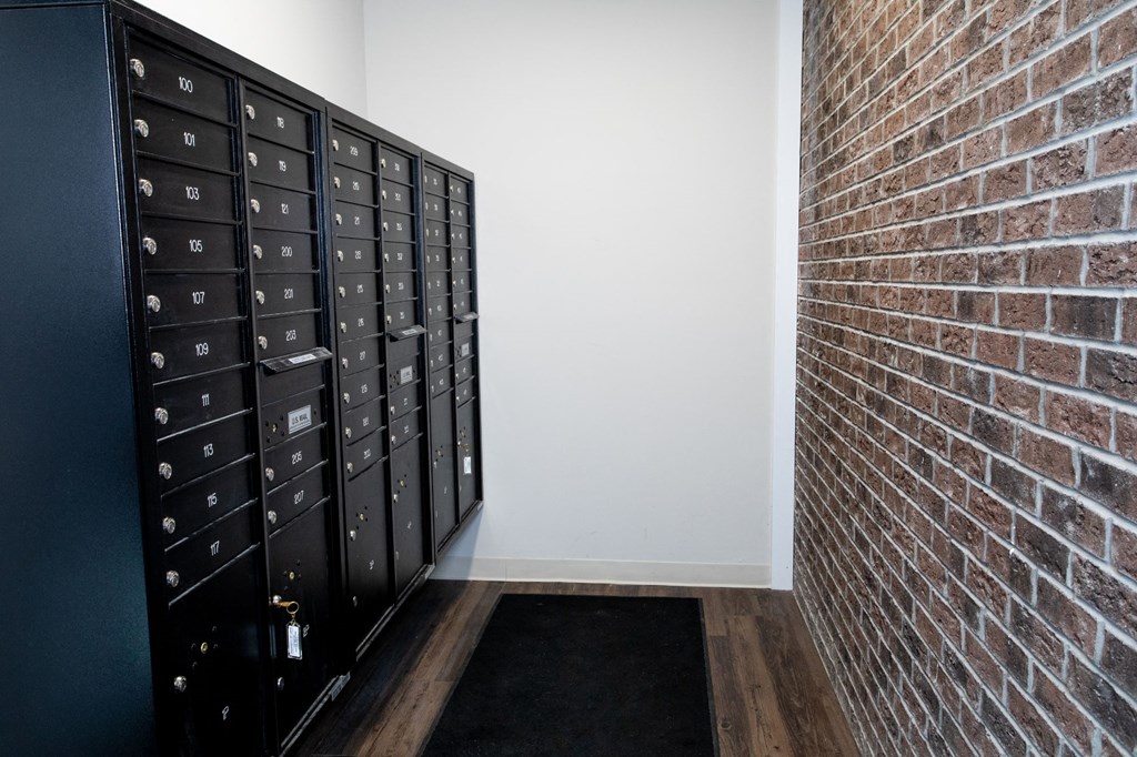 a brick wall and lockers in a room