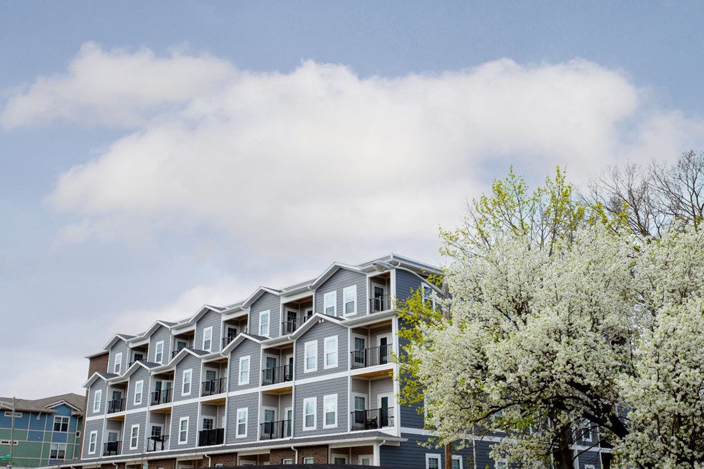 a large apartment building with trees in front of it