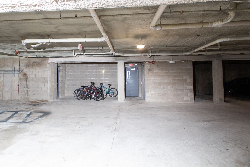 a parking garage with bikes parked in it