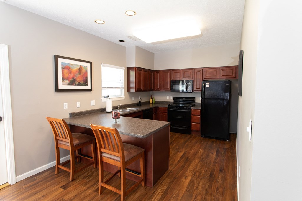 a view of a kitchen and a table with two chairs