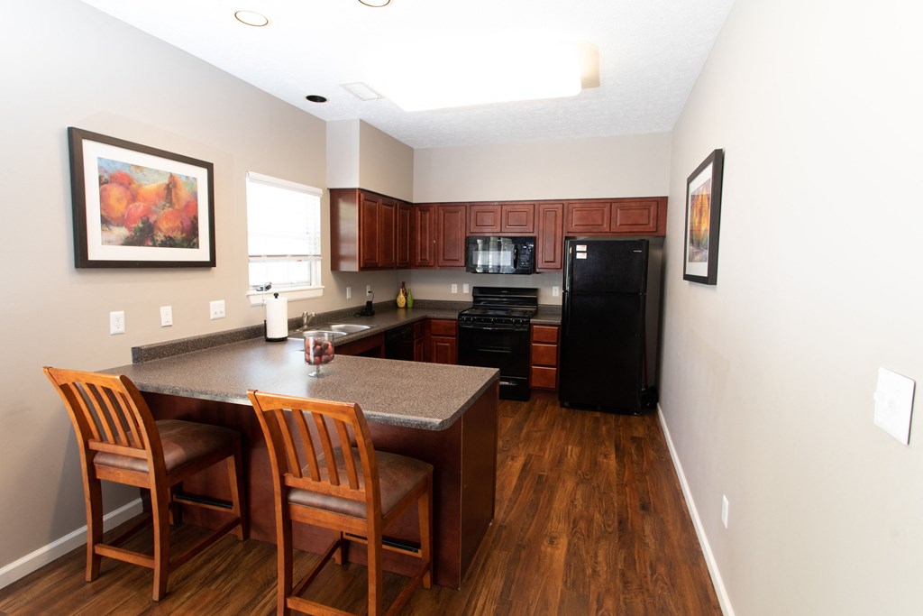 a kitchen with a island and a table with two chairs